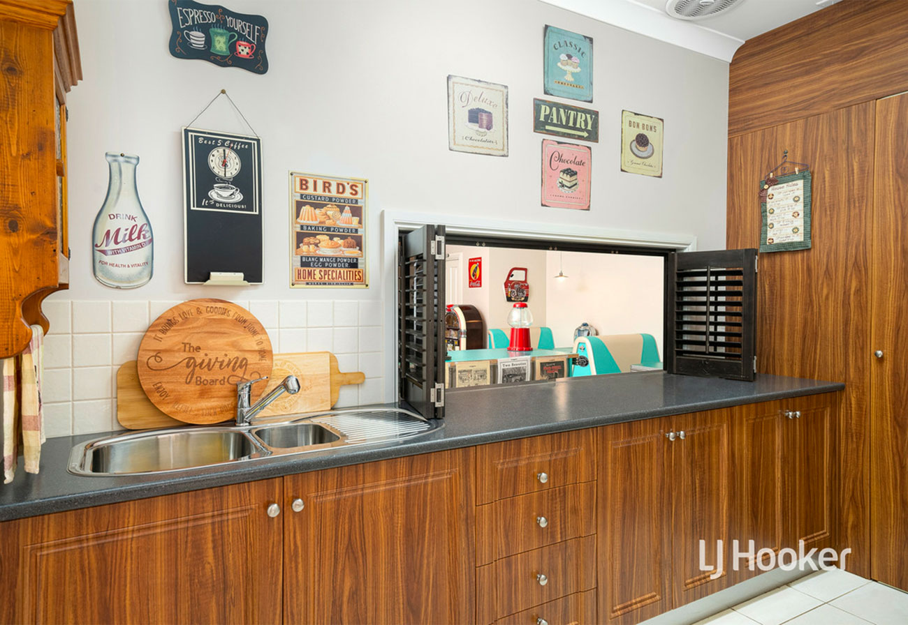 Butlers pantry at country estate with servery window to an at-home diner.