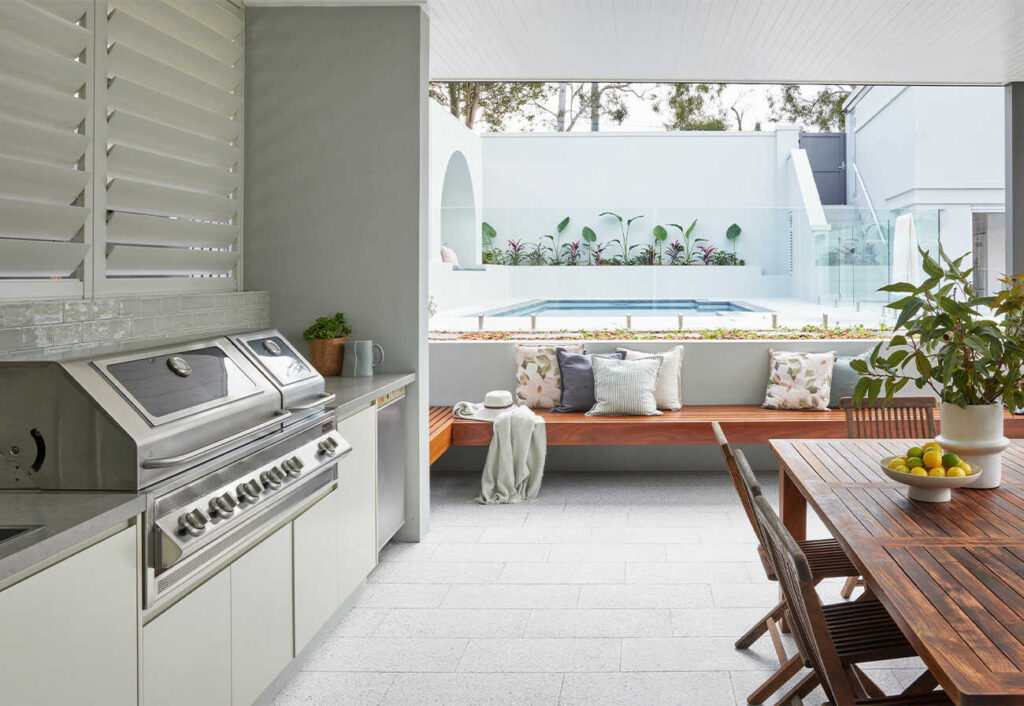 Modern alfresco area facing a swimming pool.