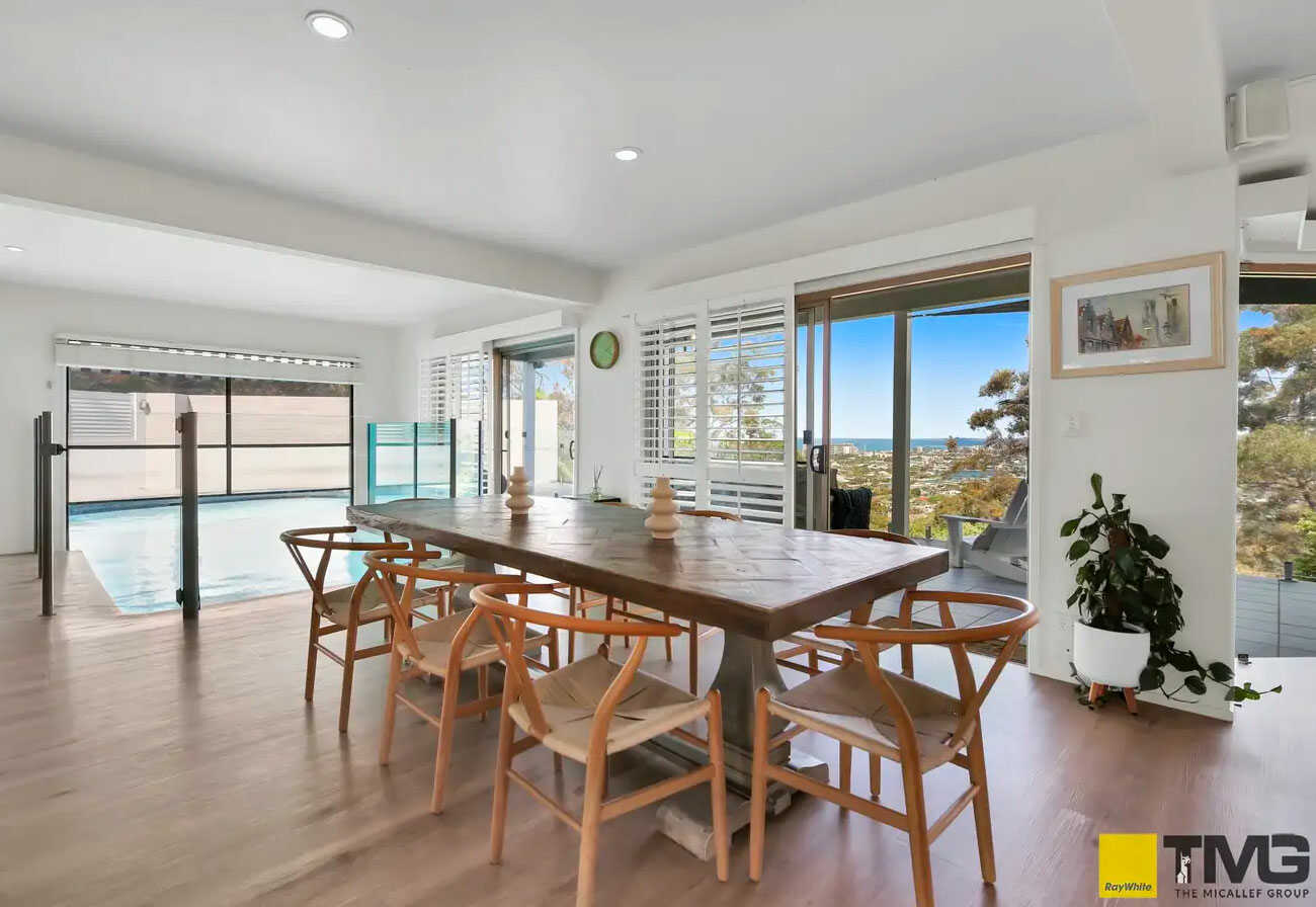 A dining room with an indoor pool.