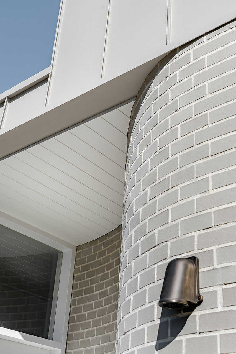 Curved outside brick wall on a home.