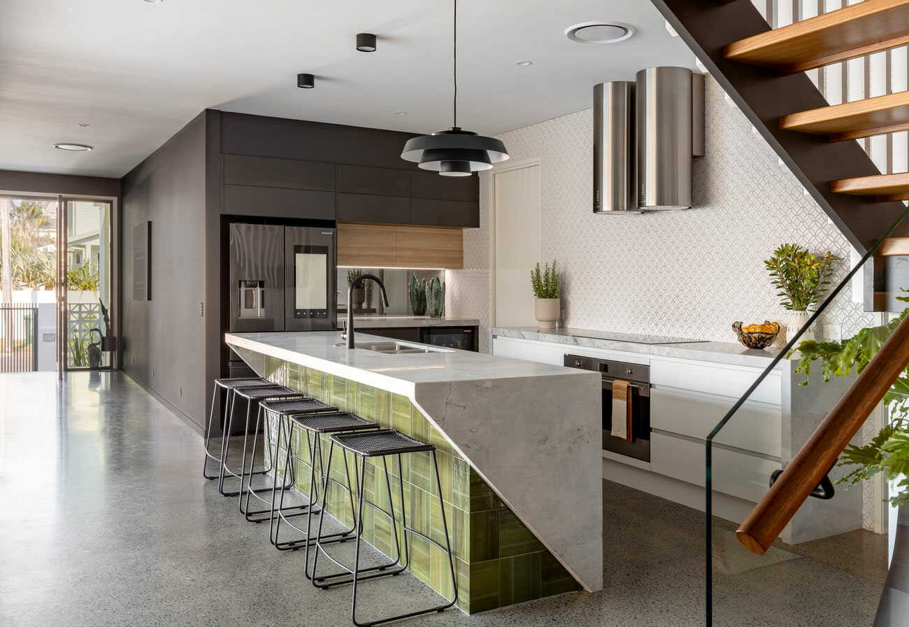 Burleigh Heads house with a marble kitchen and feature green tiles.