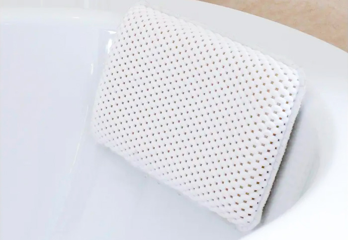 Mesh bath cushion attached to a tub.