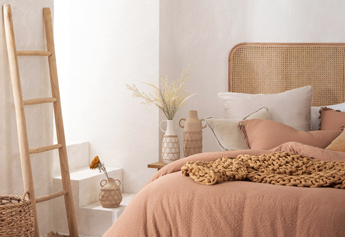 Wooden decor ladder leaning against a bedroom wall.