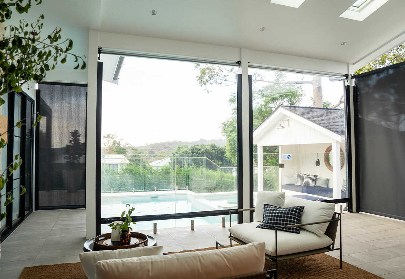 A covered alfresco area with weather-proof blinds. 