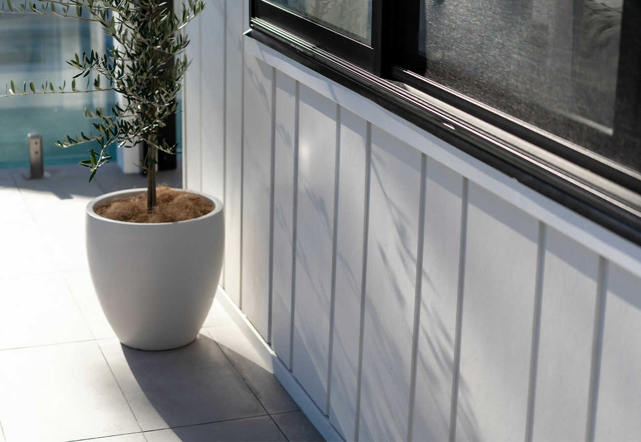 Portion of James Hardie cladding along the side of a house.