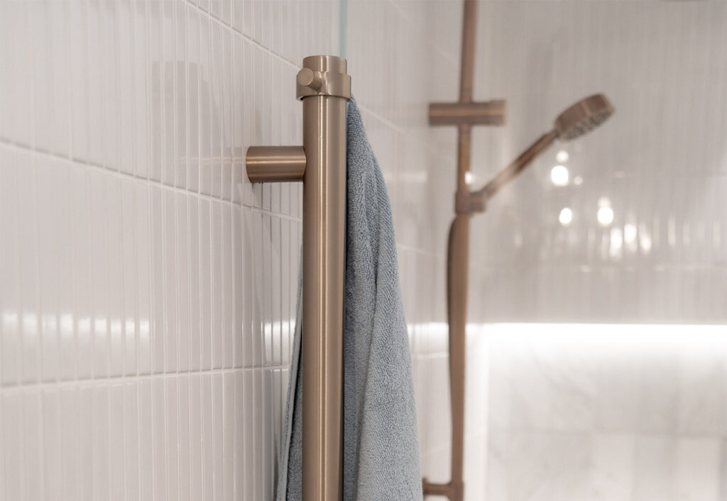 White finger tiles on a bathroom wall.