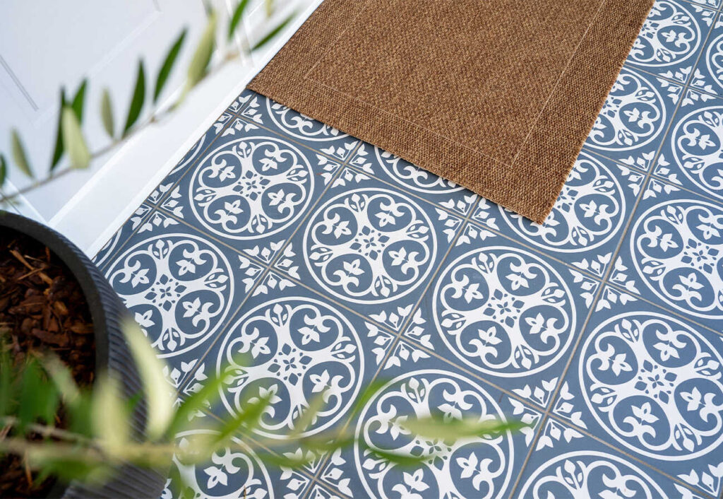 Vintage blue patterned ground tiles at a home entrance.