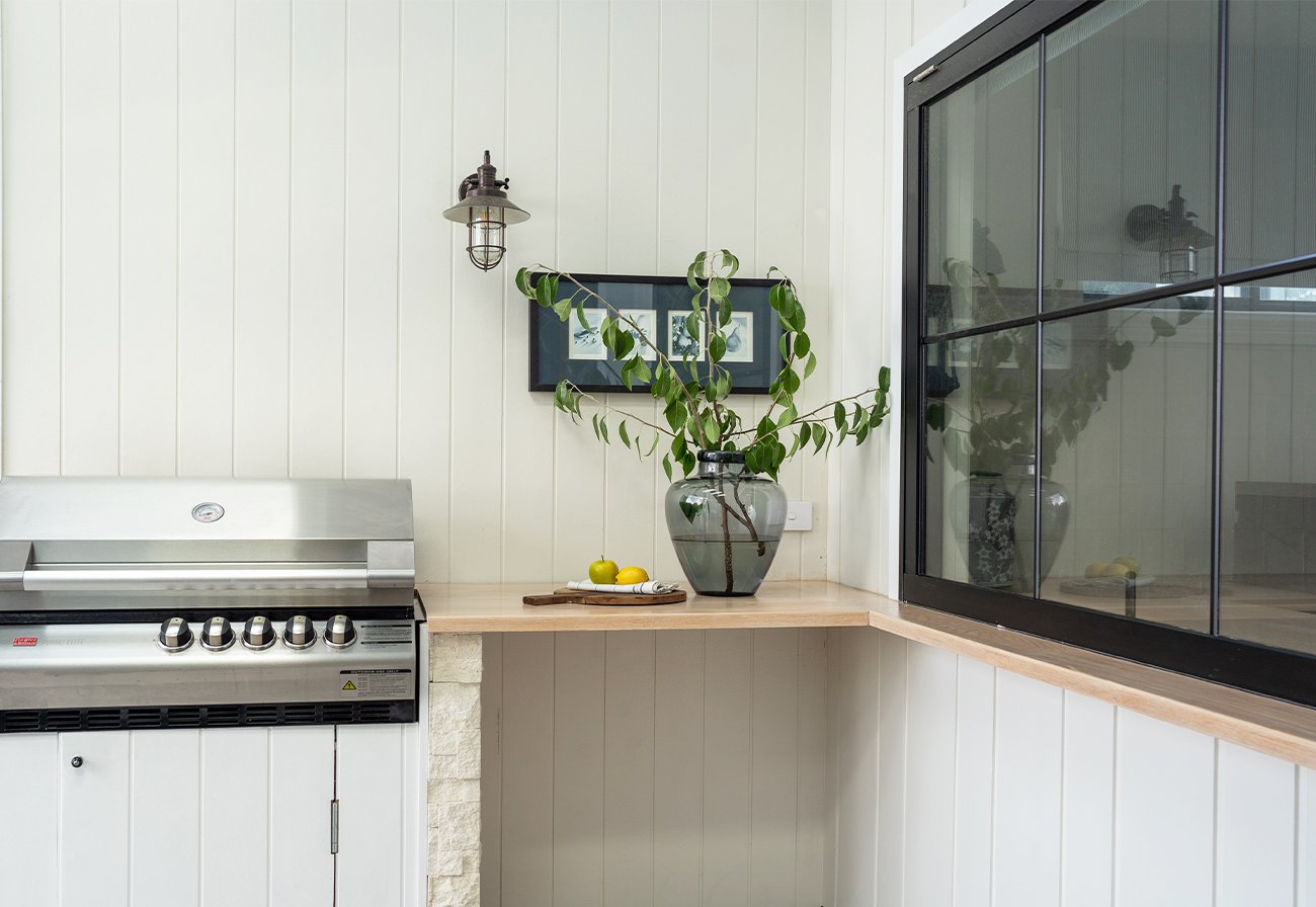 Outdoor cooking area with bench and built-in bbq.