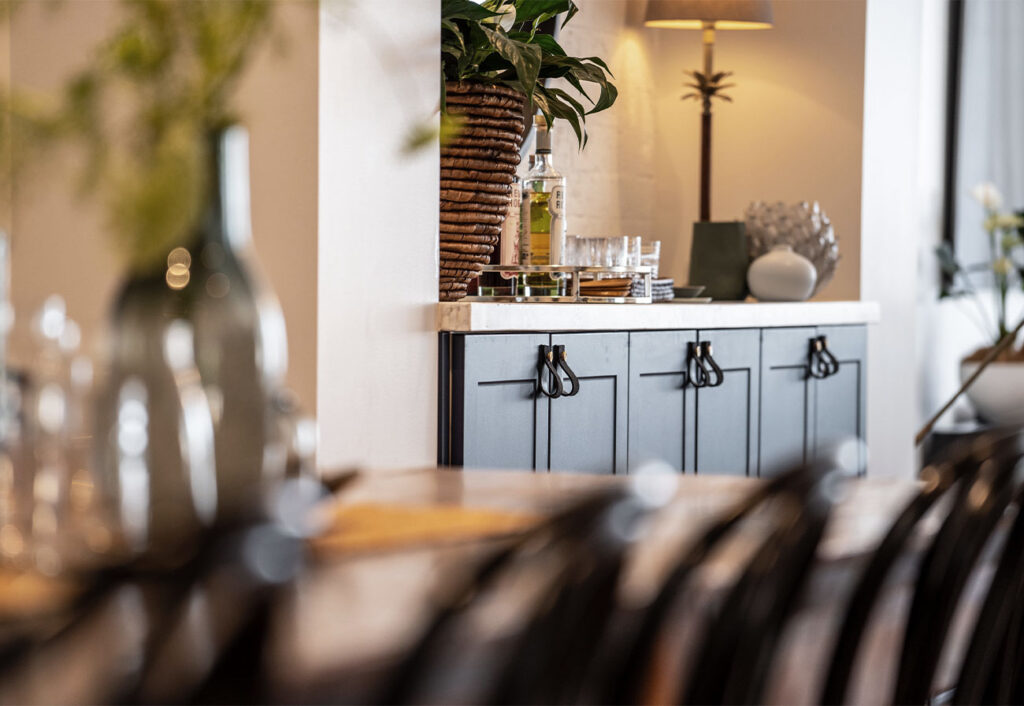 Dining table and nearby sideboard.