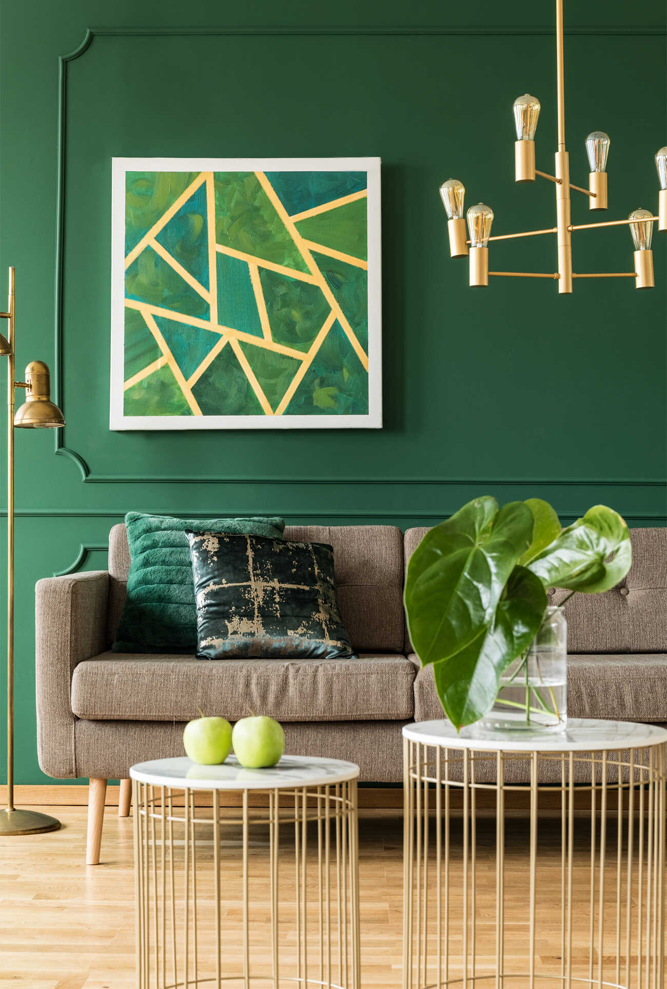 Interior sitting area with couch and bottle-green wall.