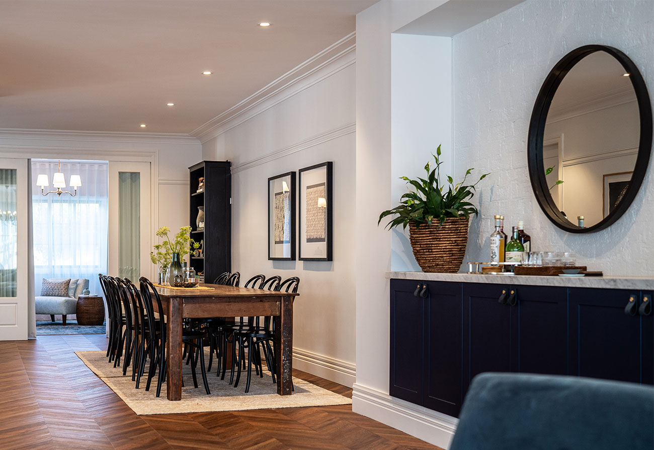 Farmhouse dining table and navy sideboard.