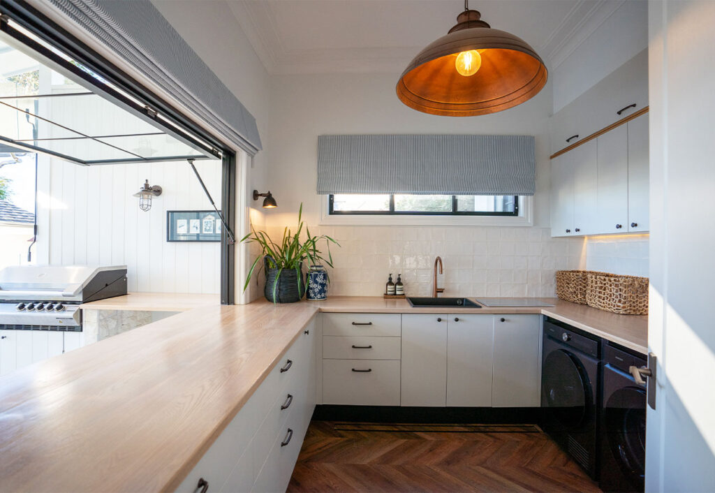 Laundry with oak benches and huge gas-strut window.