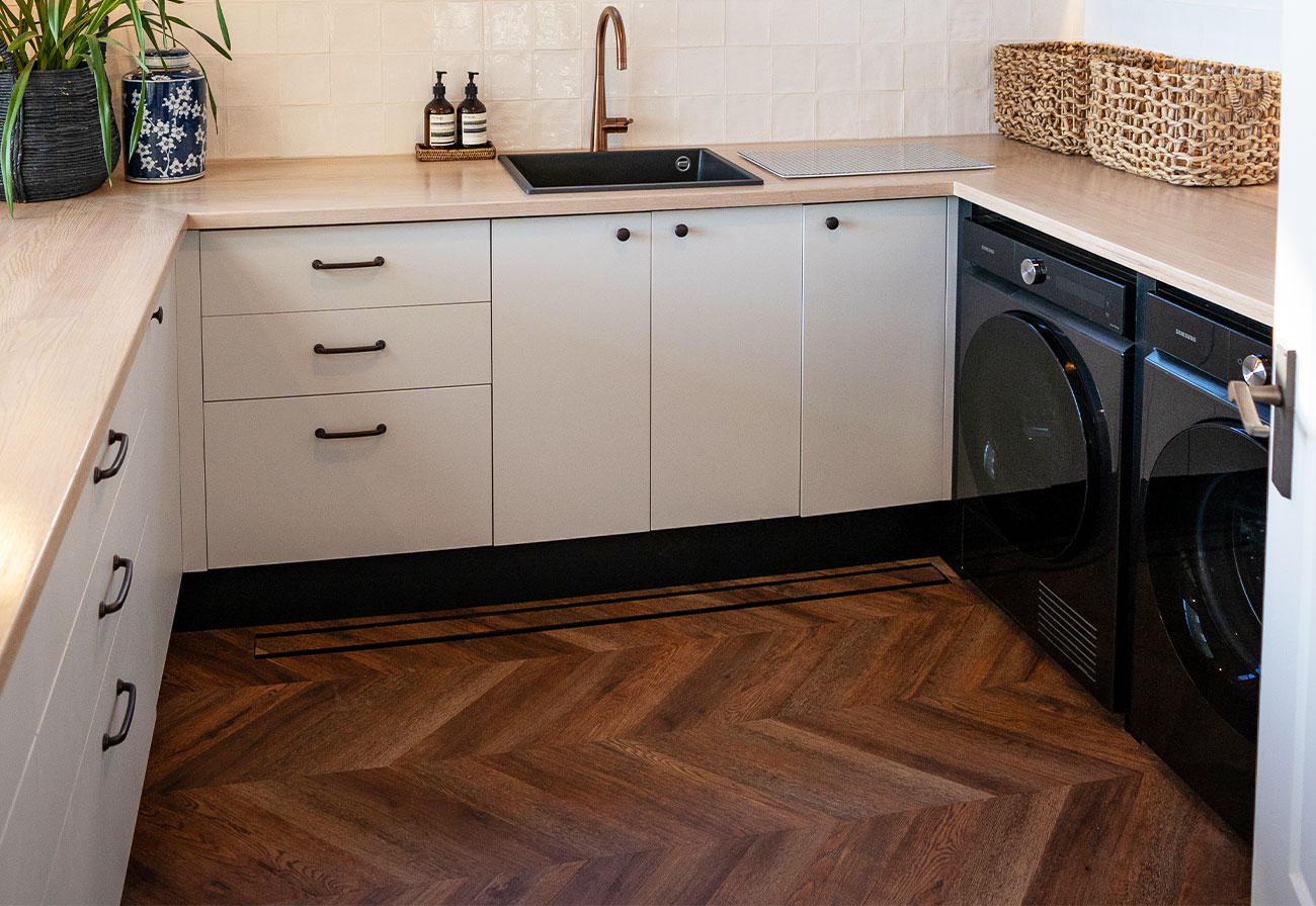 Modern Farmhouse laundry with hybrid wood floors.