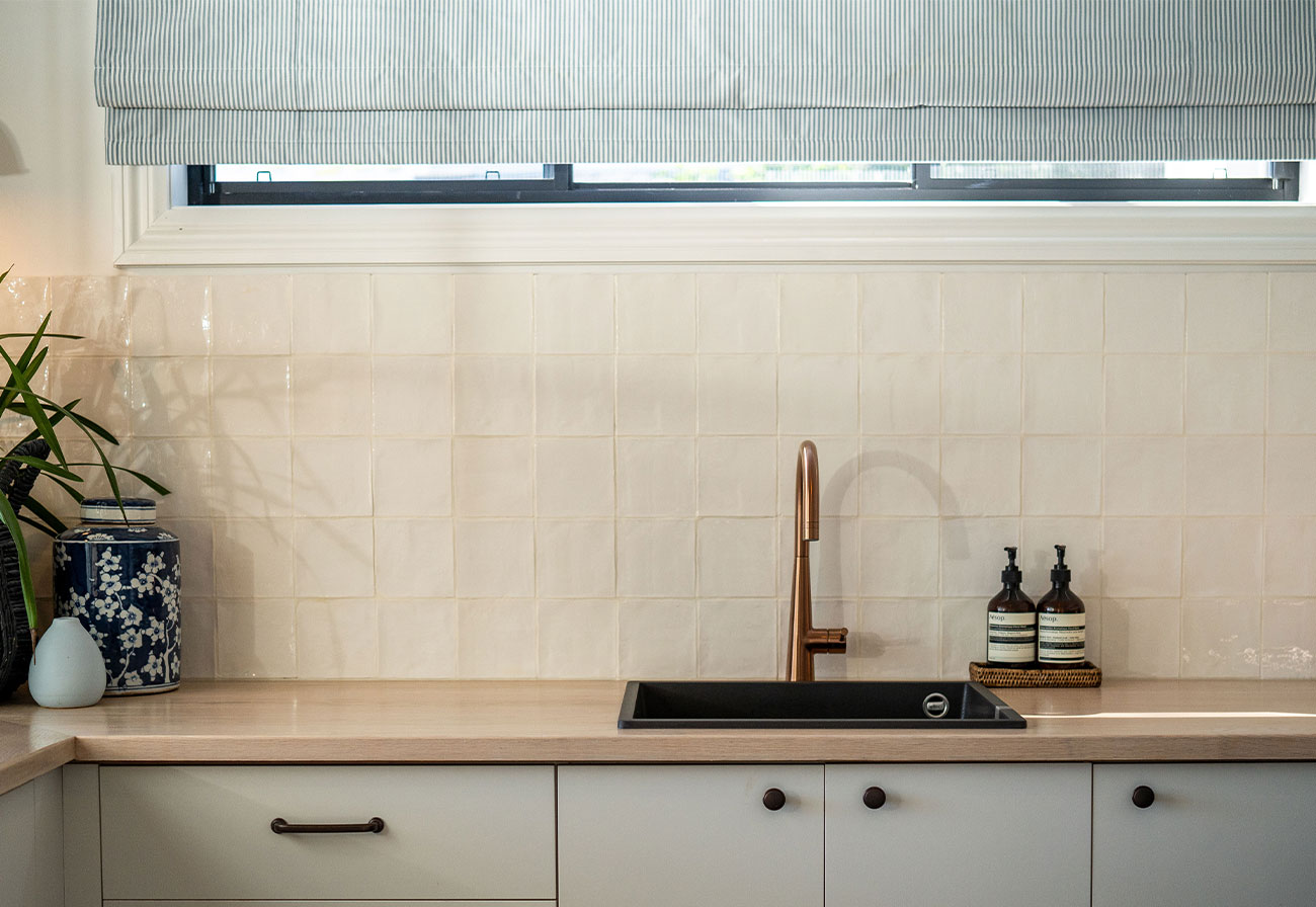 Modern Farmhouse laundry with black granitek sink and brushed copper tap.