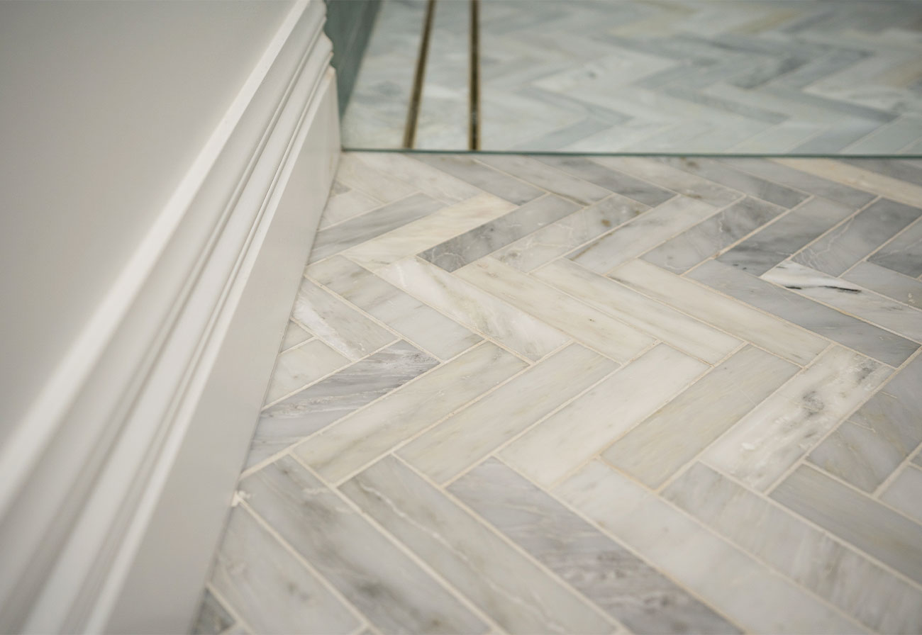 Herringbone marble bathroom tiles.