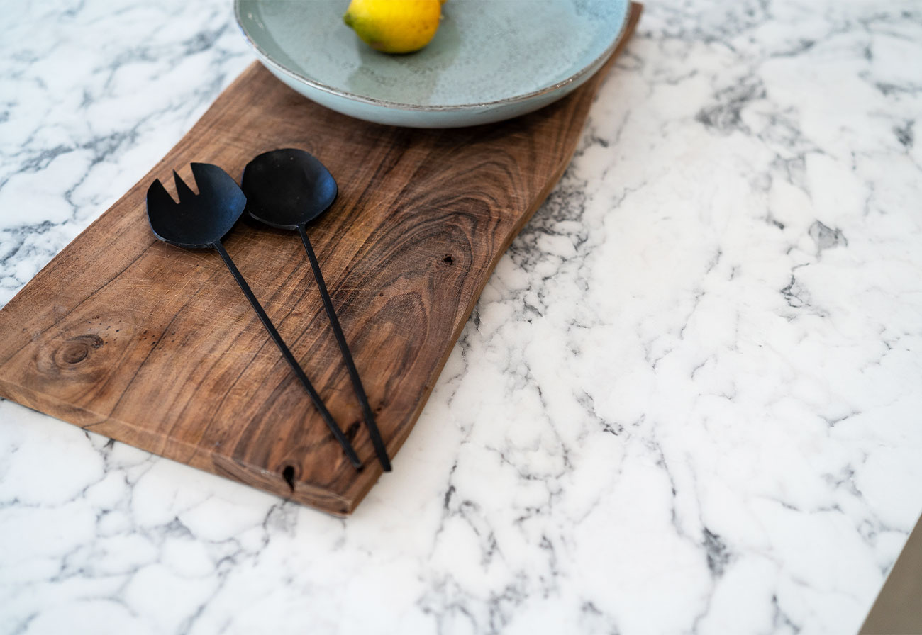 kaboodle biancoccino benchtop with a timber board on top.