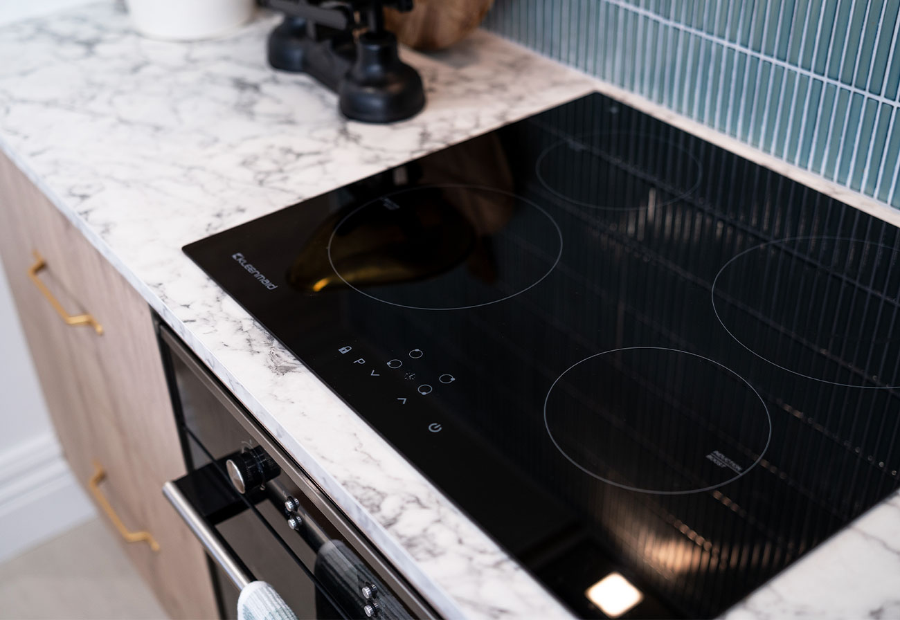 Kleenmaid 60cm induction cooktop on a marble-look benchtop.