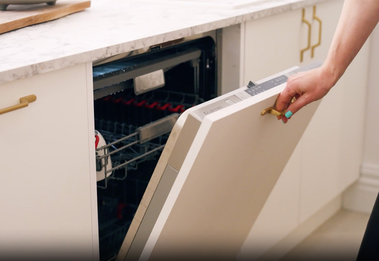 Integrated dishwasher in white kaboodle cabinetry.