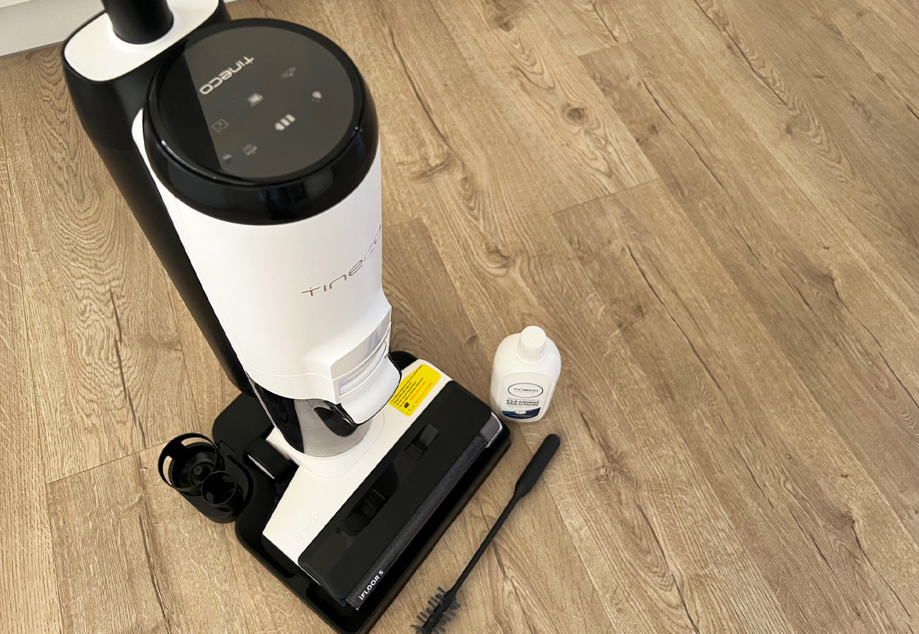 Tineco iFloor 5 Series wet and dry vacuum on wooden floorboards.