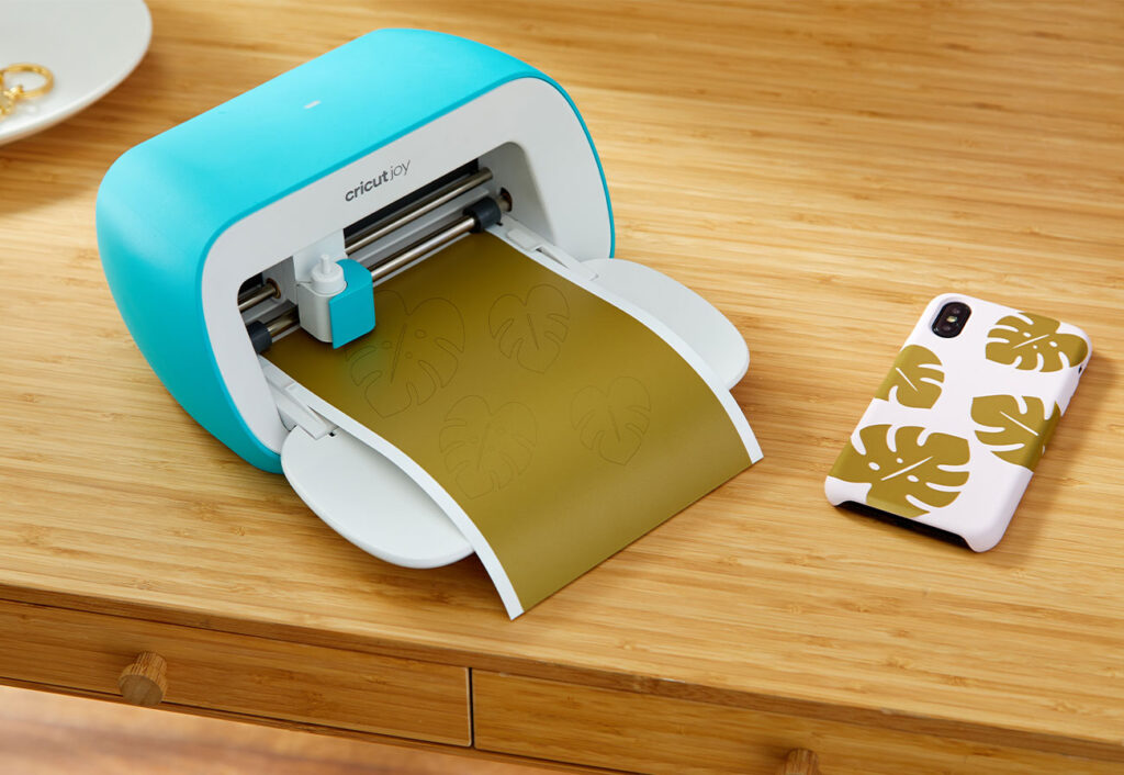 Cricut Joy machine printing onto olive green paper.