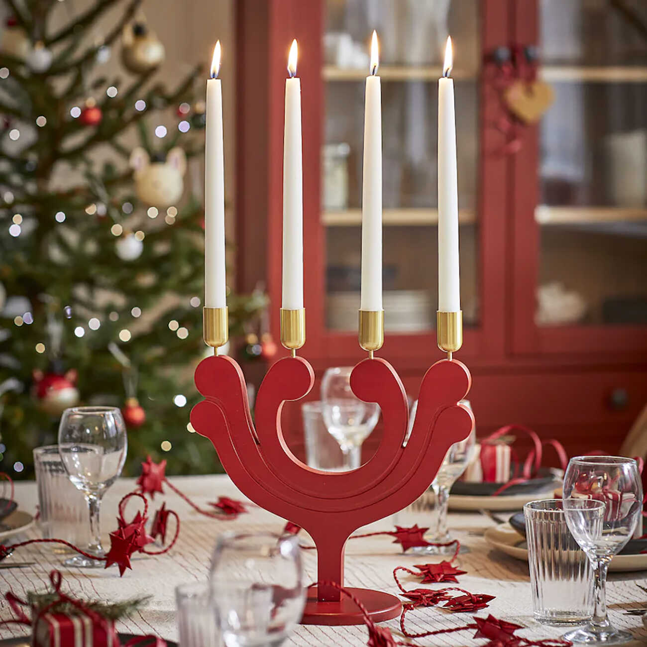 Red candle holder on a christmas table.