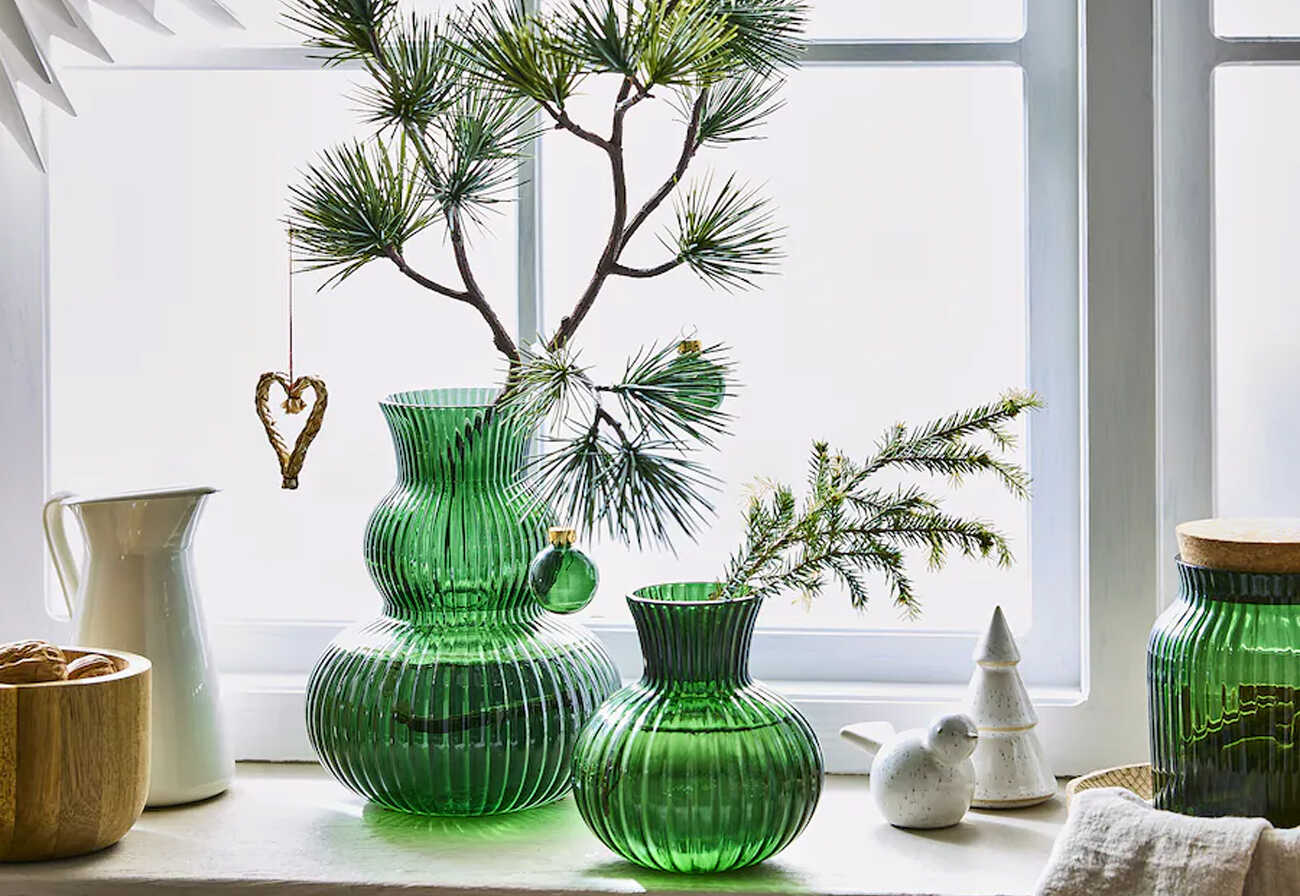 Green glass vases on a window ledge.