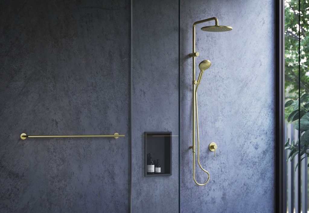 Bathroom with grey walls and brushed brass taps.