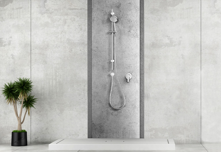 Brushed stainless rail shower in a grey bathroom.