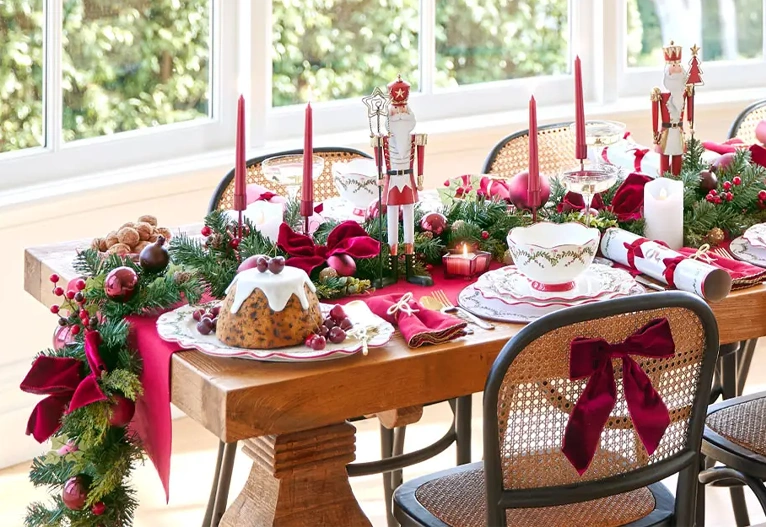 Red and green Christmas table with lush garland.