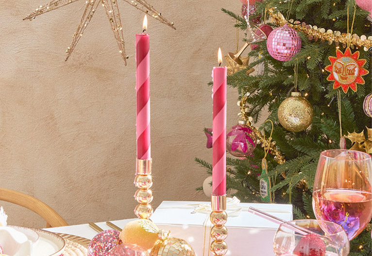 Pillow Talk Lily Stripe Taper Candle on a Christmas table.