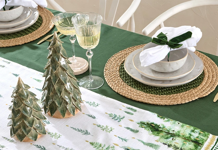 Christmas table with green tree ornaments.