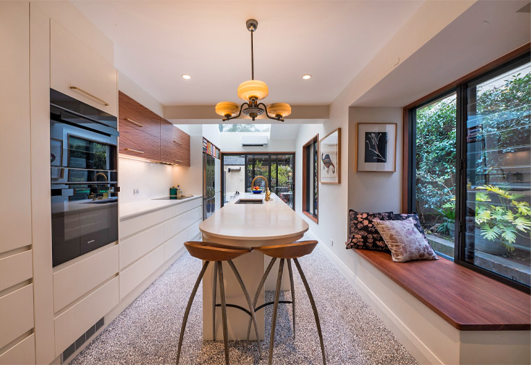 Kitchen with window bench seat and extended island bench.