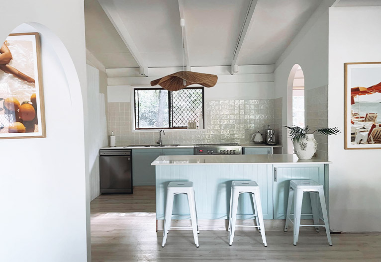 Renovated coastal kitchen with blue feature cabinetry.