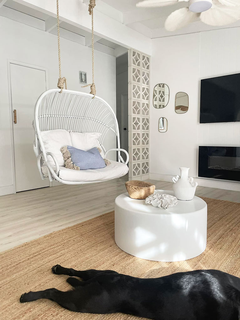 Coastal living room with  hanging chair.