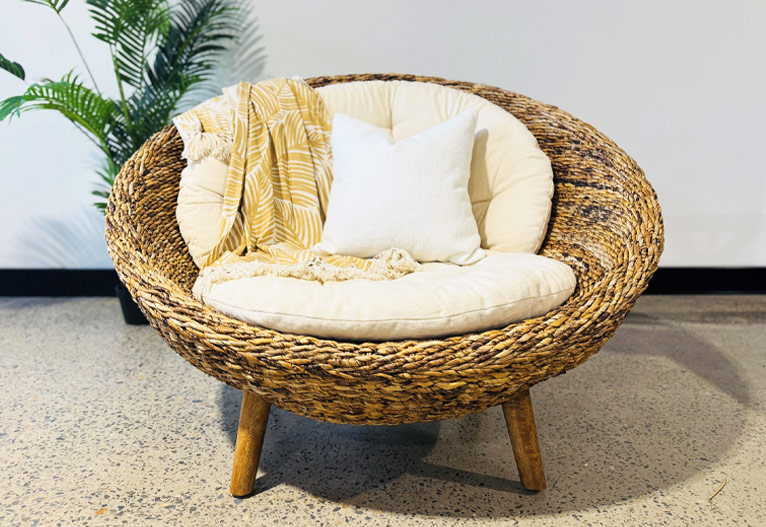 Round Sentosa Papasan Chair in wicker with cream cushions.