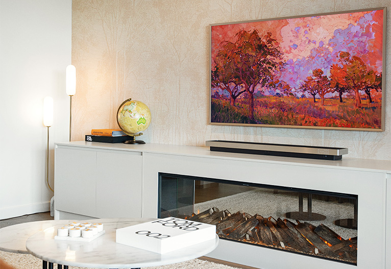 Living room with built-in faux fireplace and feature wallpaper.