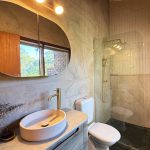 Renovated 1980s ensuite with gold tapware.