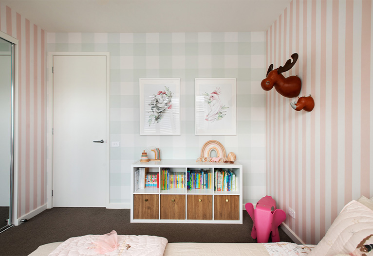 Child's bedroom with two wallpaper prints.