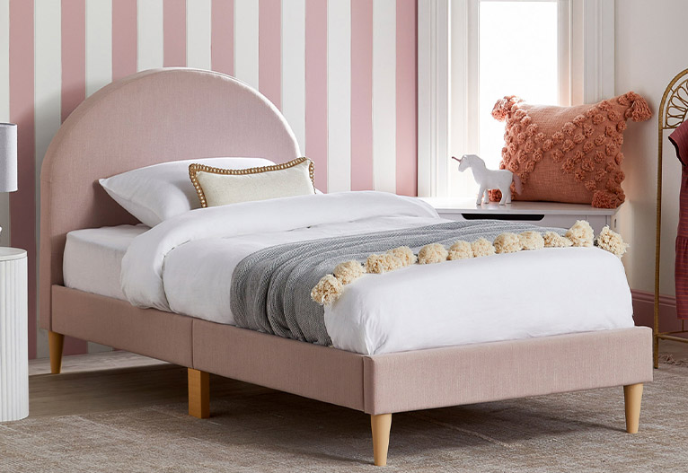 Kids' pink arched upholstered single bed.