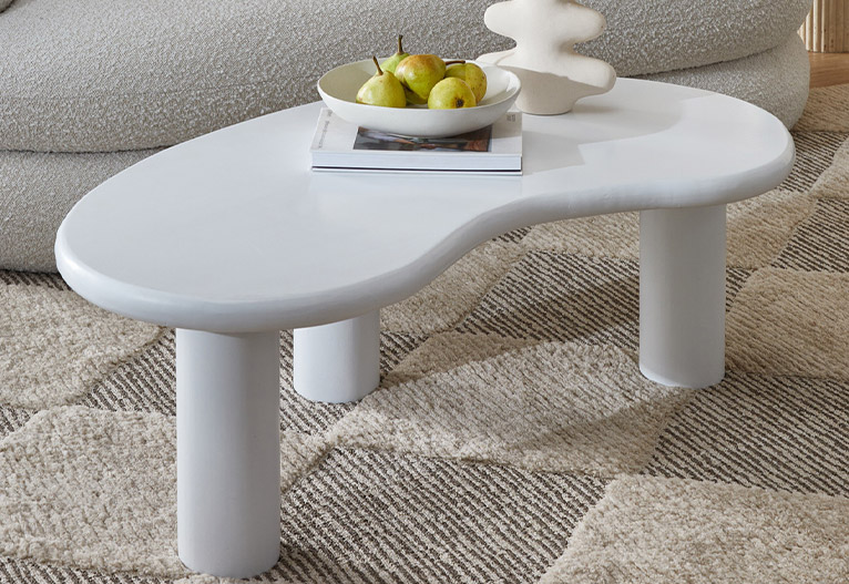 Curved white coffee table.