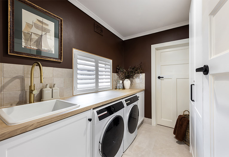 Renovated laundry with undermount washer and dryer.