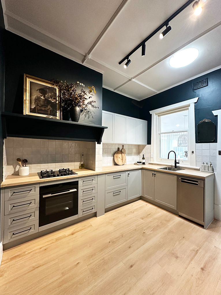 Modern kitchen with navy cabinetry.