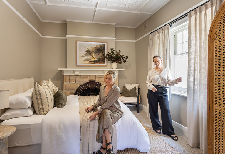 Alisa and Lysandra in a renovated bedroom.