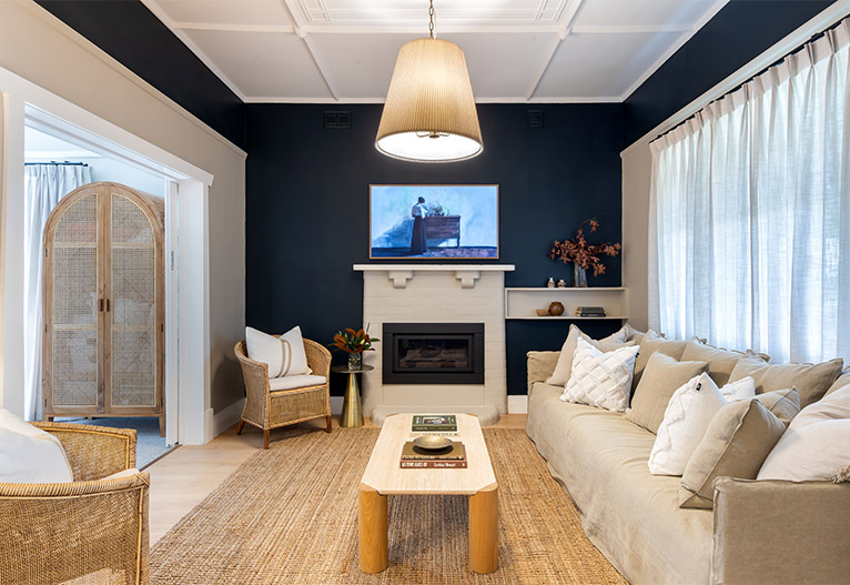 Renovated living room with navy walls. 