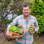 Jason Hodges holding a bottle of Charlie Carp fertiliser.