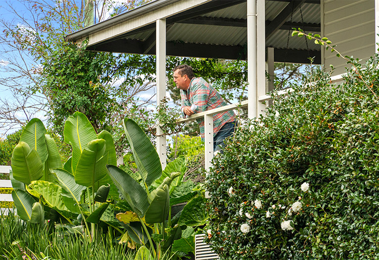 Jason Hodges observing garden from a deck.