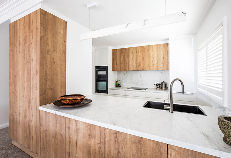 Renovated kitchen with walnut elements.