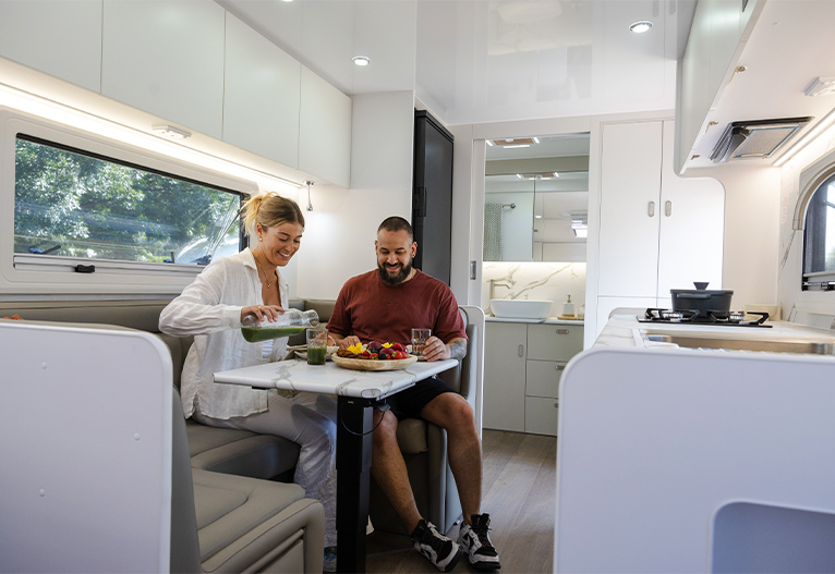 Couple sitting in a luxurious Crusader Caravan.