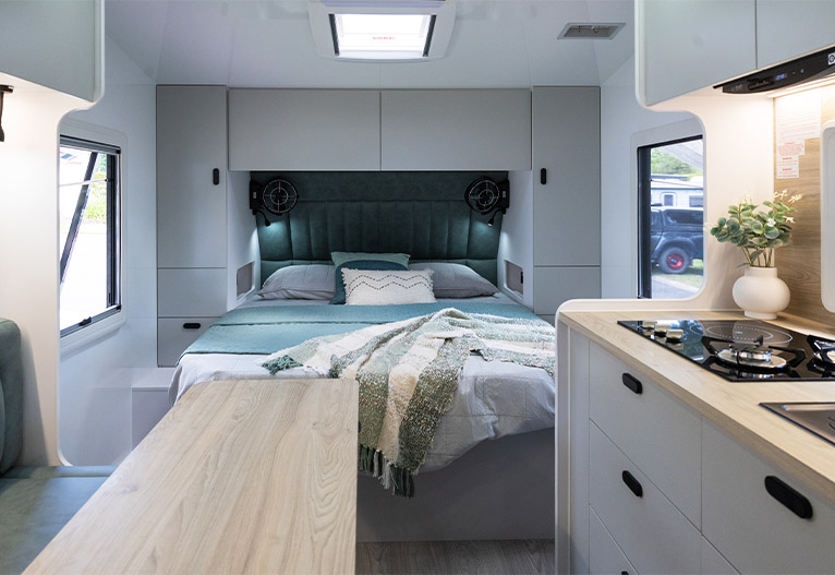 Master bed inside a modern caravan.