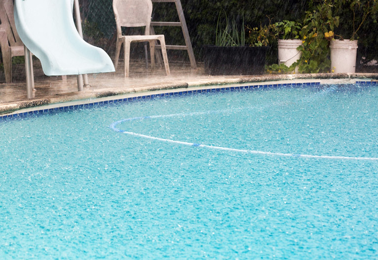 Rain on a backyard pool.